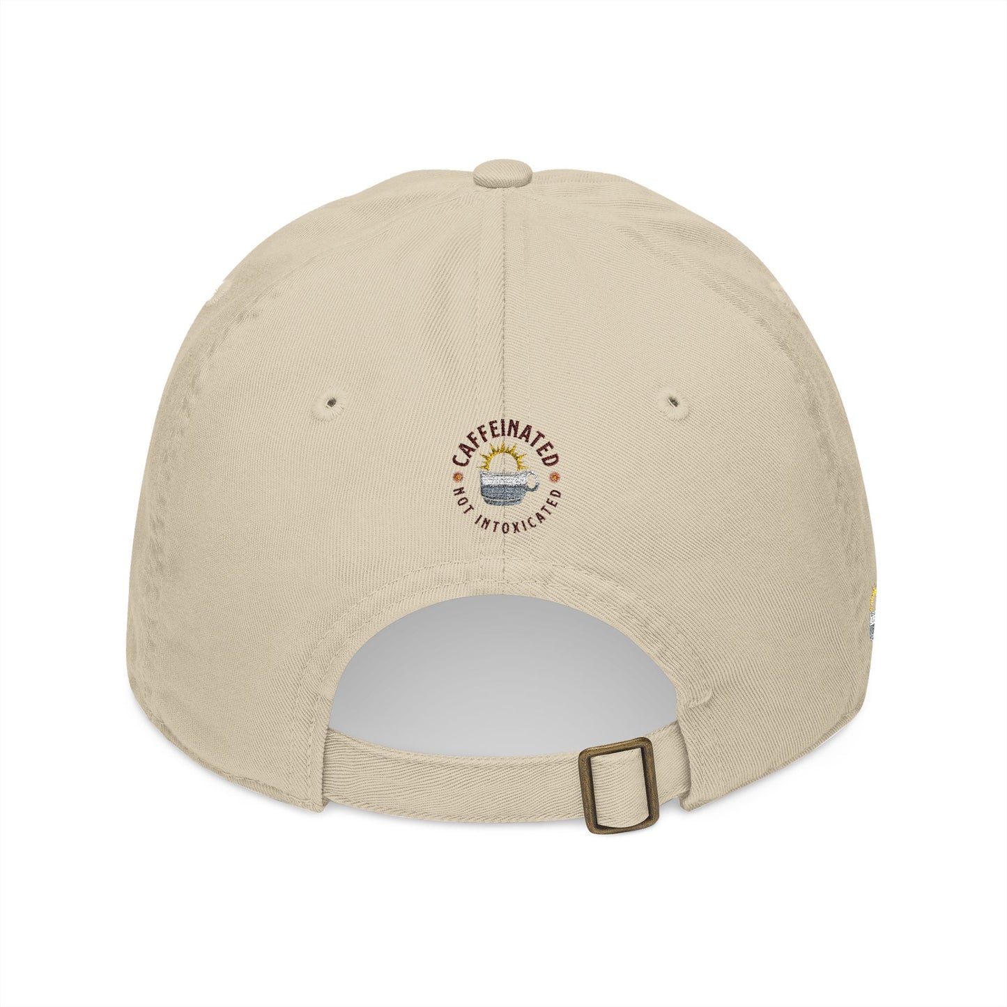 Back profile of beige cap showing circular 'Caffeinated Not Intoxicated' embroidered logo with coffee cup and sunrise graphic, adjustable buckle strap